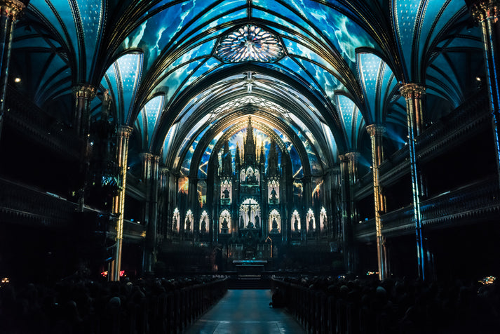 The interior of Notre-Dame Basilica lit up in blue during Moment Factory's AURA light show