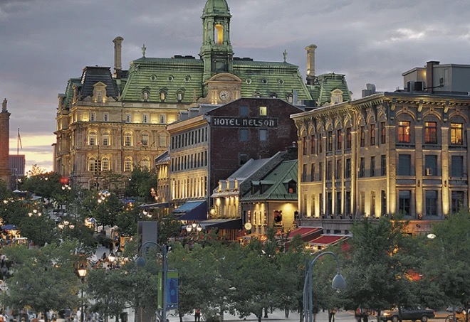 Place Jacques-Cartier at dusk, terraces and string lights below the green-domed City Hall and the Hôtel Nelson